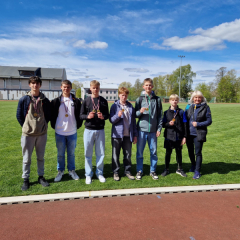 Vieglatlētikas sacensībās - zēnu komanda un skolotāja.