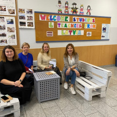 Saldus pamatskolas skolotājas sēž Slovēnijas skolas vestibilā.